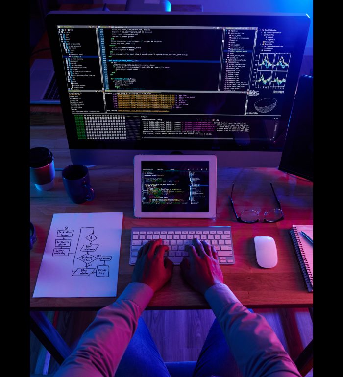 top-view-unrecognizable-hacker-performing-cyberattack-night (1)